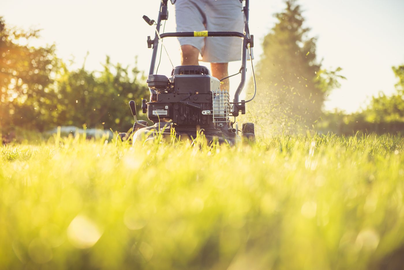 Landscaper mowing a lawn