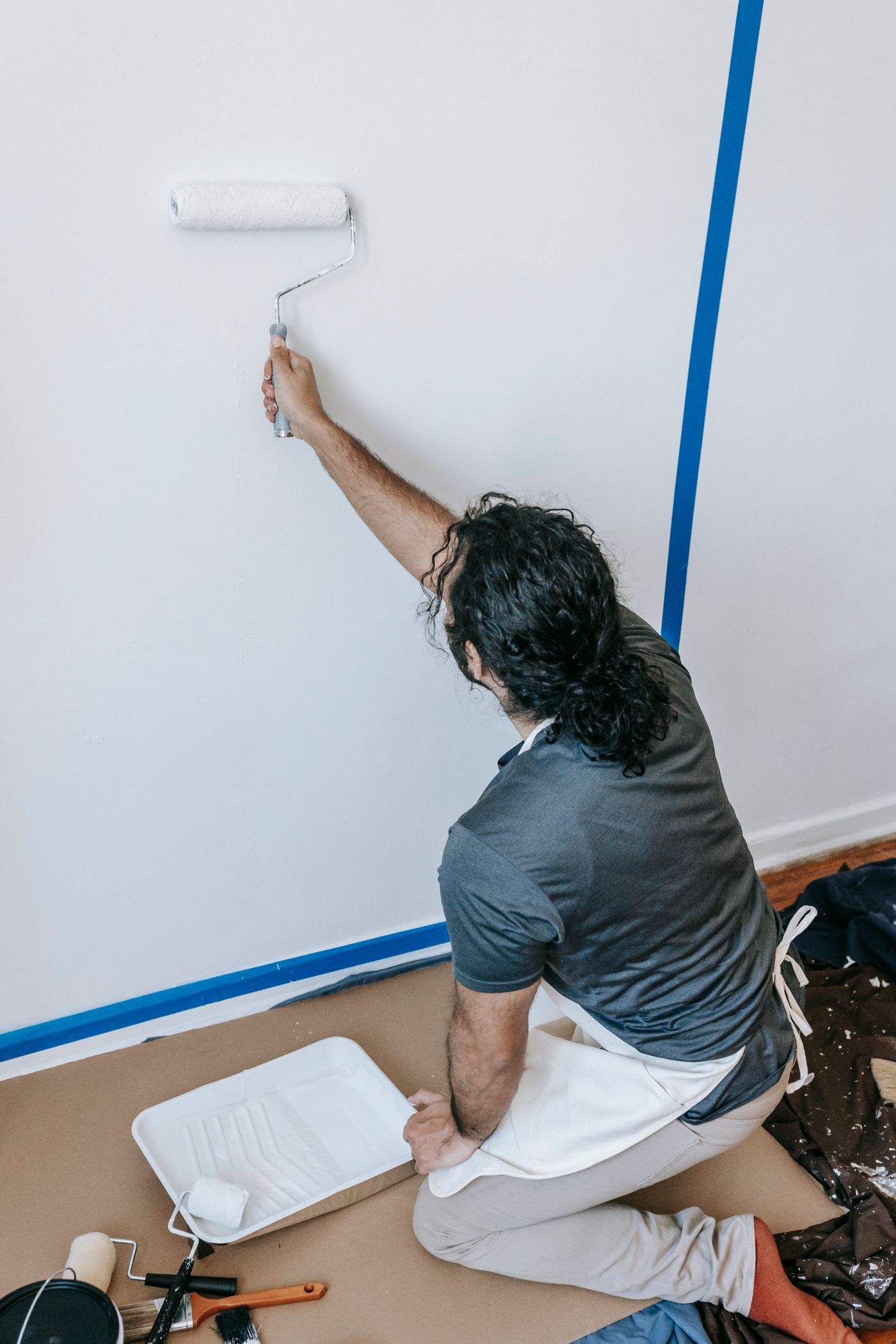 Painter rolling a wall